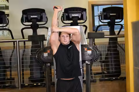 Demonstrasi gerakan Standing Low-Pulley One-Arm Triceps Extension.